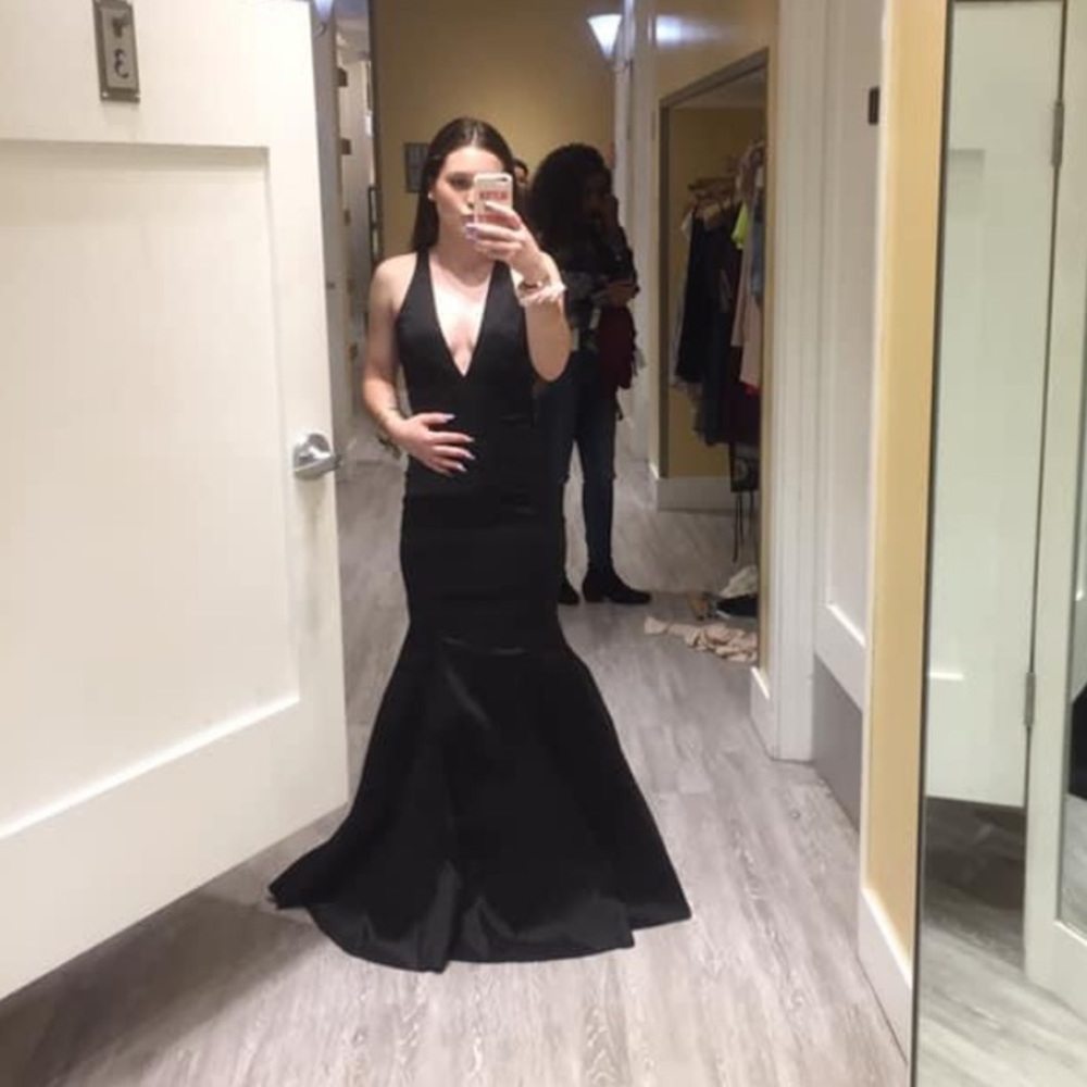 Black, Mermaid Fitting Prom dress. Layers underneath to make the dress poof.